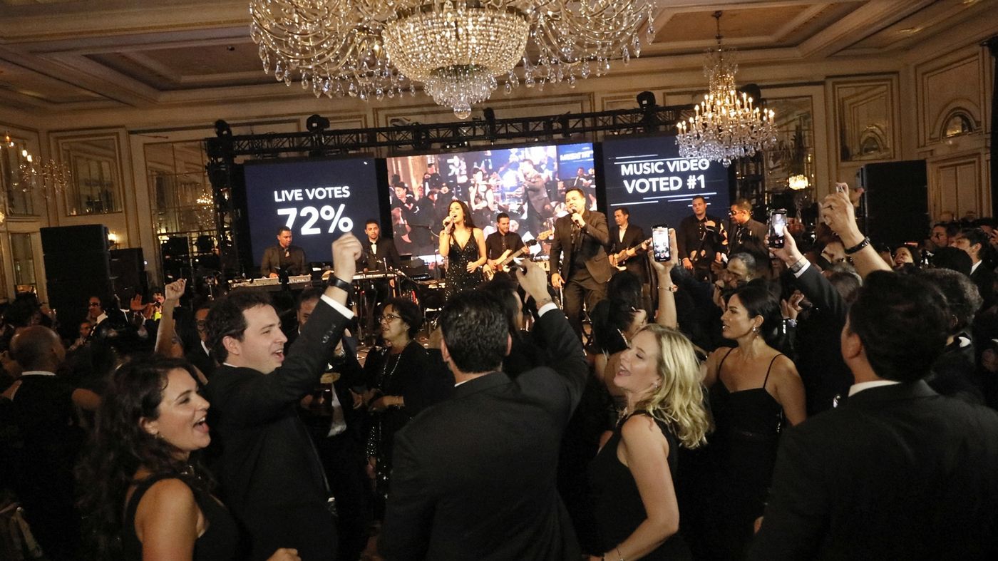 Band performing at a sales kickoff with dynamic lighting